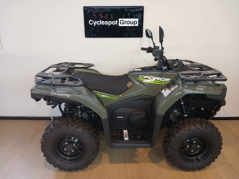 Load image into Gallery viewer, Green CF Moto C-Force 400 non-eps model on a wooden floor in front of a Cyclespot Group sign