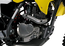 Load image into Gallery viewer, Close-up of a motorcycle engine and exhaust system, showing a silver engine block, black exhaust pipe, and yellow body panel on a white background.