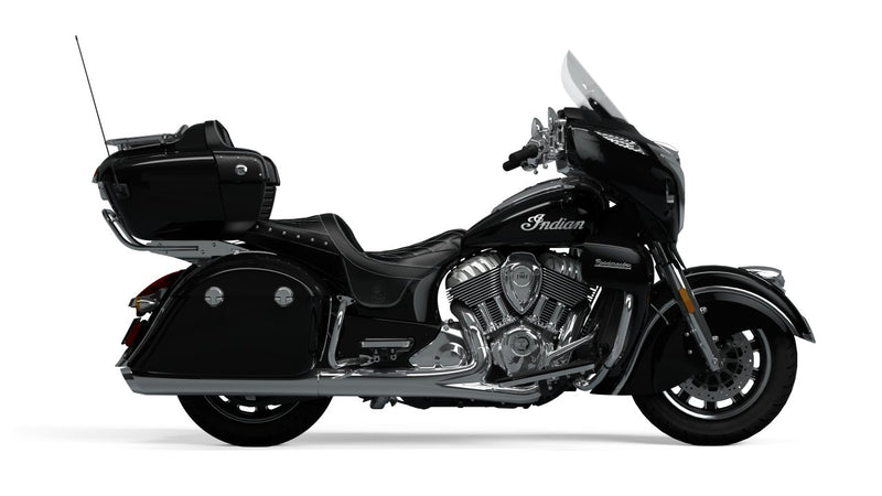 Load image into Gallery viewer, A black Indian Roadmaster touring motorcycle with chrome engine components, side storage cases, and a windshield, shown in profile against a plain white background.
