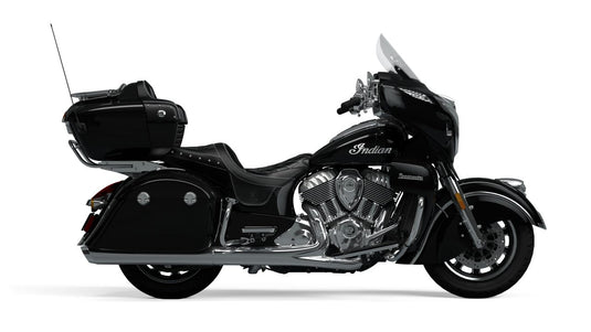 A black Indian Roadmaster touring motorcycle with chrome engine components, side storage cases, and a windshield, shown in profile against a plain white background.