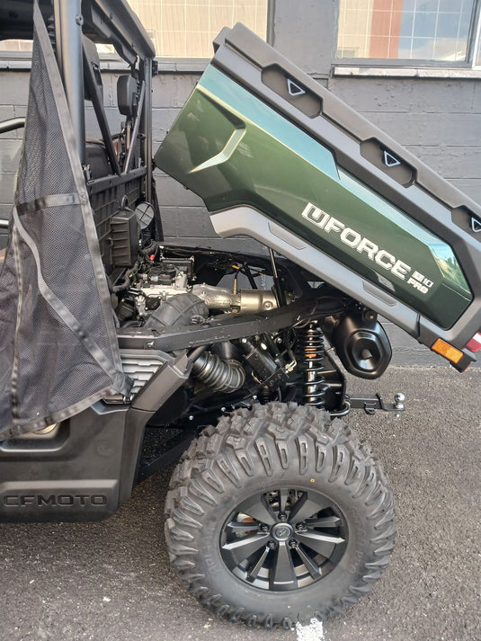 Close-up of a vehicle with a lowed Tray and off-road tire on a street.