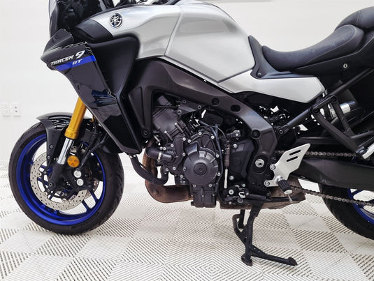 Close-up of a 2021 Yamaha Tracer 9 GT motorcycle on a checkered floor