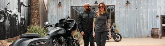 A man and woman in premium Indian Motorcycle lifestyle gear and casual apparel posing with touring motorcycles at Cyclespot NZ.