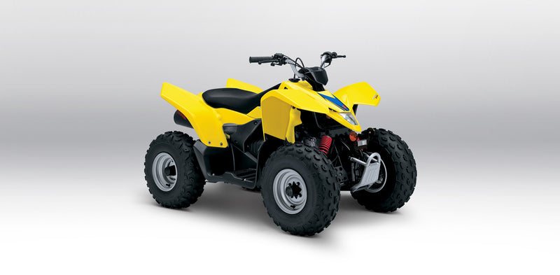 Load image into Gallery viewer, A yellow and black 2025 Suzuki LT-Z90 QuadSport 90 with large knobby tires, shown from a three-quarters angle on a light gray studio background.
