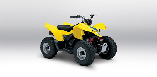A yellow and black 2025 Suzuki LT-Z90 QuadSport 90 with large knobby tires, shown from a three-quarters angle on a light gray studio background.