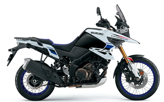 Suzuki 2025 Suzuki V-Strom 1050 RJ Adventure motorcycle in a side profile view, featuring a black and white body with blue and red accents, a tall windscreen, and gold front fork, set against a plain white background.