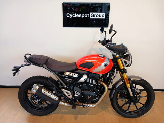 2026 Triumph Scrambler 400 X in Baja Orange with 398cc engine, 39.5HP, 6-speed transmission, 150mm suspension travel and LAMS approval.