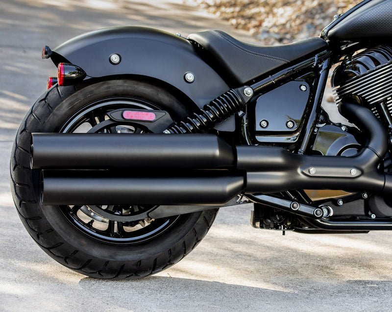 Load image into Gallery viewer, Close-up of a black 2026 Indian Chief Dark Horse cruiser motorcycle showing the rear wheel, dual exhaust pipes, fender, and side bodywork on an outdoor paved surface.
