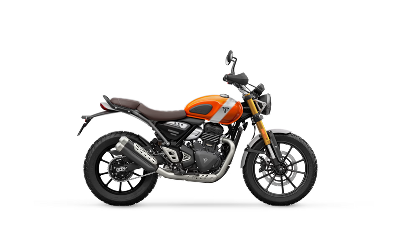 Load image into Gallery viewer, A side profile view of a Triumph Scrambler 400 motorcycle on a solid white background. The motorcycle features a vibrant orange fuel tank, a brown leather seat, black wheels, and silver metallic engine components.
